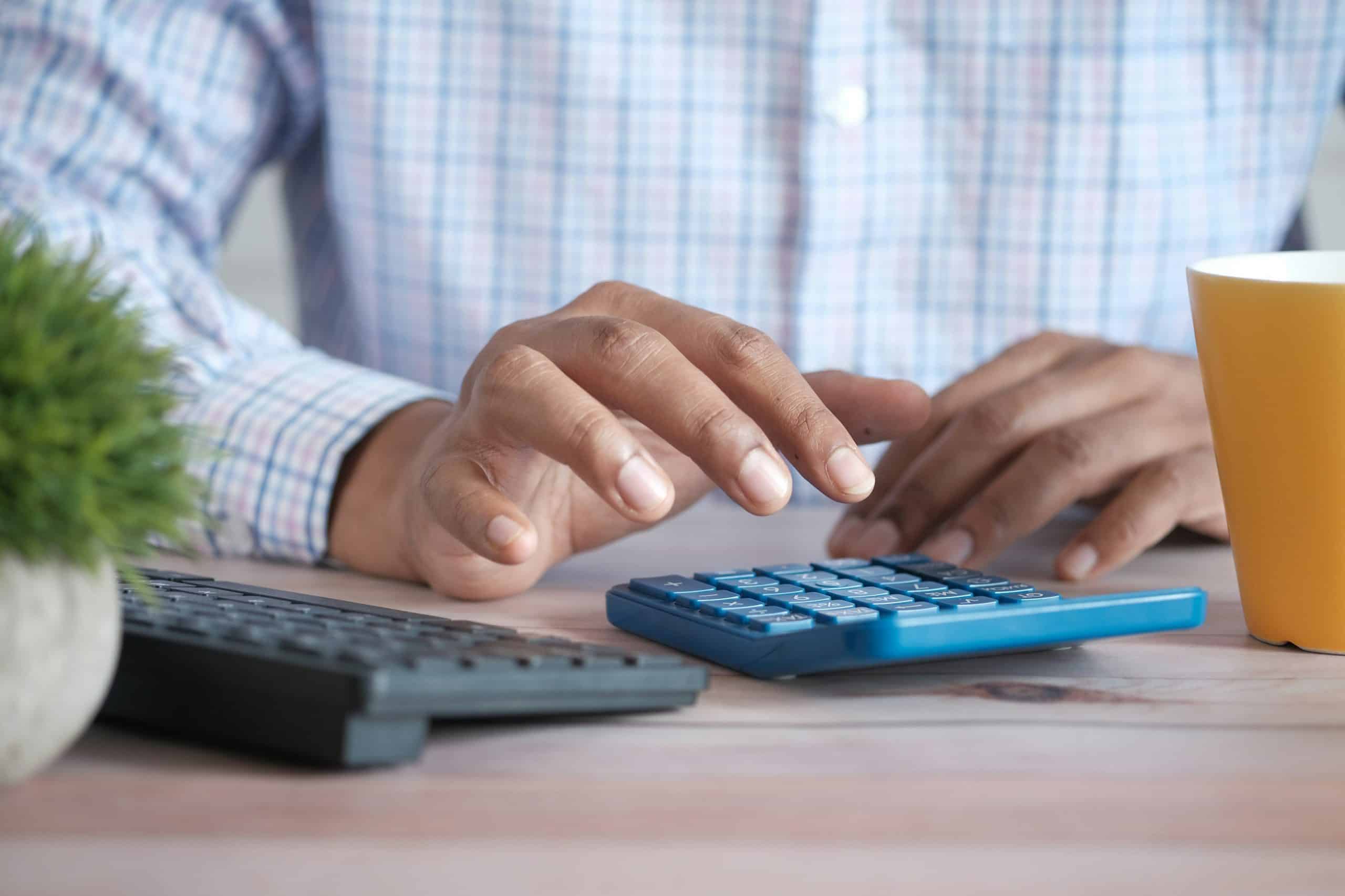 researcher crunching numbers on a calculator